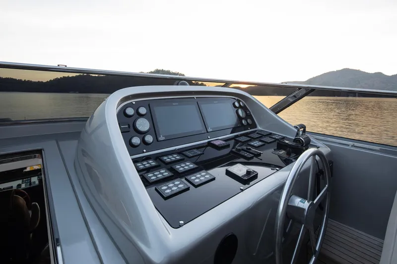  Yacht Photos Pics Helm of 2009 Canados 110 yacht with modern navigation controls at sunset.