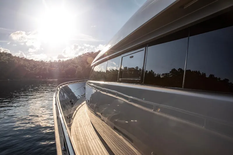  Yacht Photos Pics Luxurious 2009 Canados 110 yacht reflecting sunlight on calm waters.