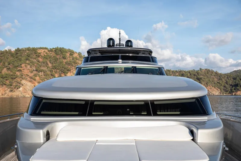  Yacht Photos Pics Luxury Canados 110 yacht from 2009 on serene water with scenic backdrop.