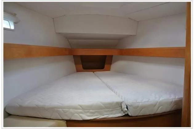  Yacht Photos Pics Cozy cabin interior of 2010 Jeanneau Sun Odyssey 42 DS sailboat with twin mattresses.