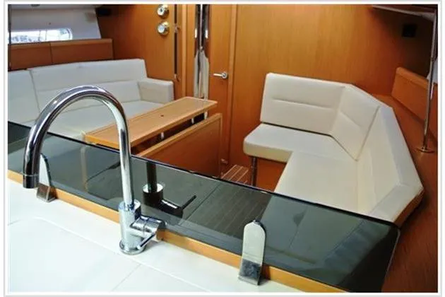  Yacht Photos Pics Interior of 2010 Jeanneau Sun Odyssey 42 DS yacht with modern seating and kitchen area.