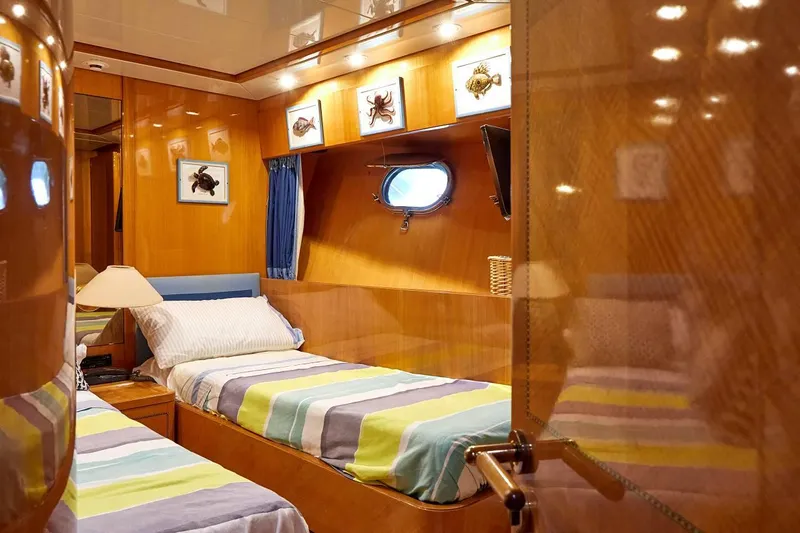 Kinglass VI Yacht Photos Pics Luxurious 1999 Sanlorenzo SL82 yacht cabin with twin beds and elegant wood paneling.