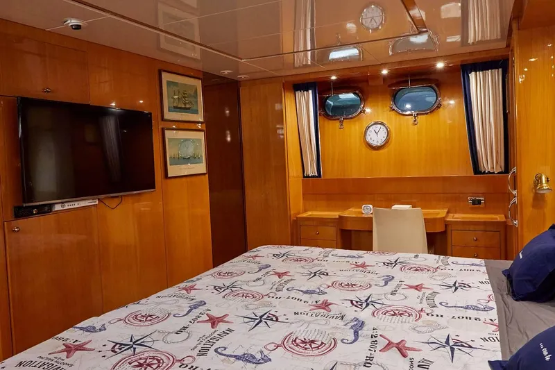 Kinglass VI Yacht Photos Pics Luxurious cabin interior of 1999 Sanlorenzo SL82 yacht with nautical decor and wood paneling.