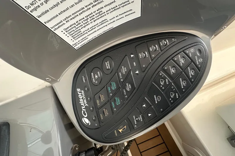 Sassy II Yacht Photos Pics Control panel of 2008 Cruisers Yachts 415 Express Motoryacht with various switches and labels.