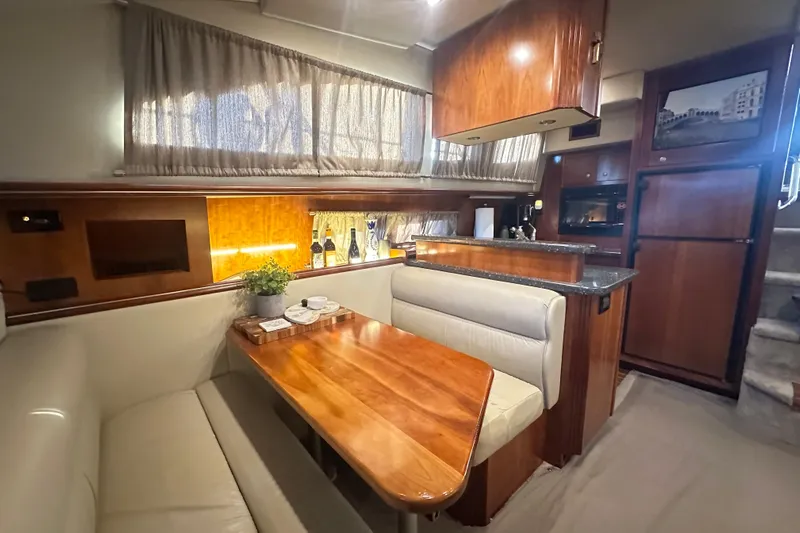 Sassy II Yacht Photos Pics Luxurious interior of 2008 Cruisers Yachts 415 Express Motoryacht with elegant dining area.