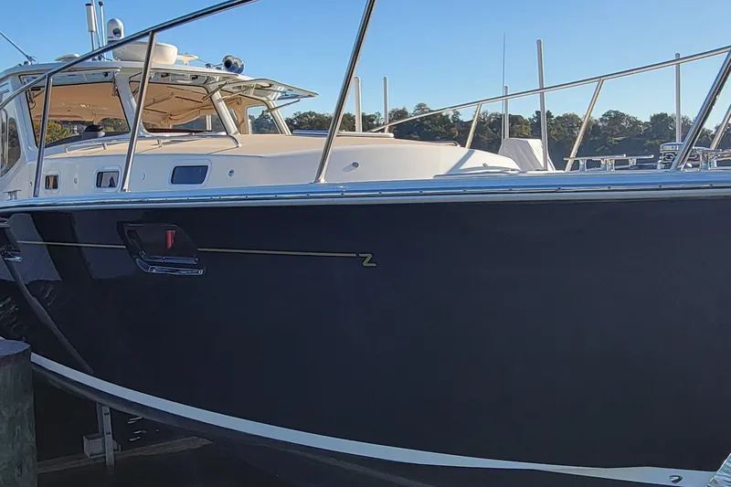 Captivator Yacht Photos Pics 2017 MJM 40z Downeast boat docked, showcasing sleek design and elegant structure.