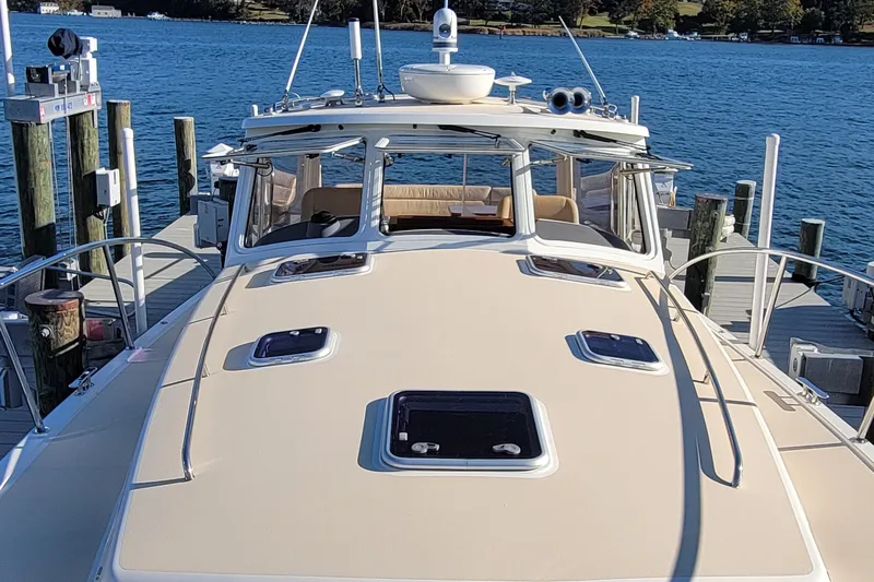 Captivator Yacht Photos Pics 2017 MJM 40z Downeast yacht docked at marina, showcasing sleek design and spacious deck.