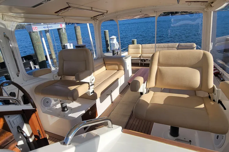 Captivator Yacht Photos Pics 2017 MJM 40z Downeast yacht interior with beige seating and ocean view.