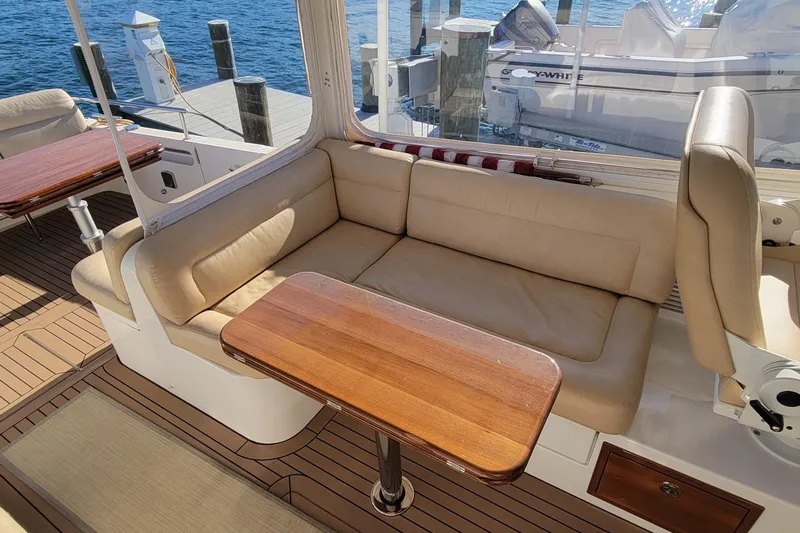 Captivator Yacht Photos Pics 2017 MJM 40z Downeast yacht interior with beige seating and wooden table.