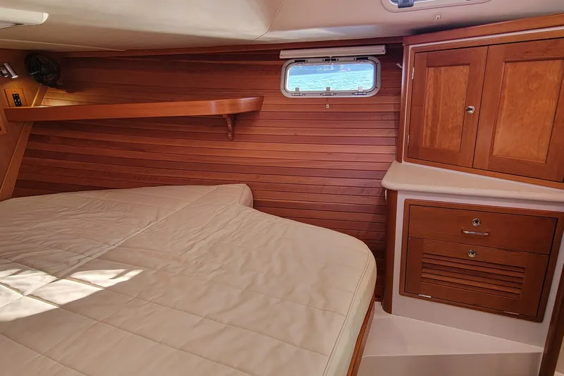 Captivator Yacht Photos Pics Cozy cabin interior of 2017 MJM 40z Downeast with wood paneling and storage cabinets.