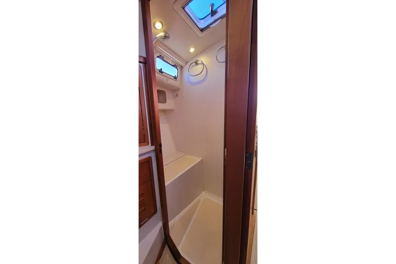 Captivator Yacht Photos Pics 2017 MJM 40z Downeast yacht interior shower with wooden accents and overhead lighting.