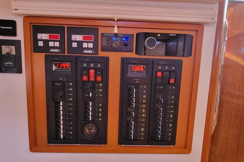 Captivator Yacht Photos Pics Electrical control panel on a 2017 MJM 40z Downeast boat, featuring digital displays and switches.