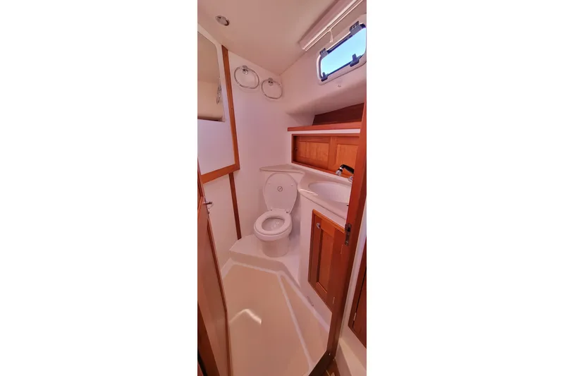 Captivator Yacht Photos Pics 2017 MJM 40z Downeast yacht bathroom with wooden cabinets and compact design.