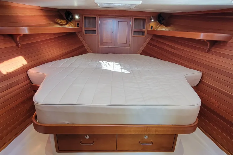 Captivator Yacht Photos Pics 2017 MJM 40z Downeast cabin with wooden interior and spacious bed.