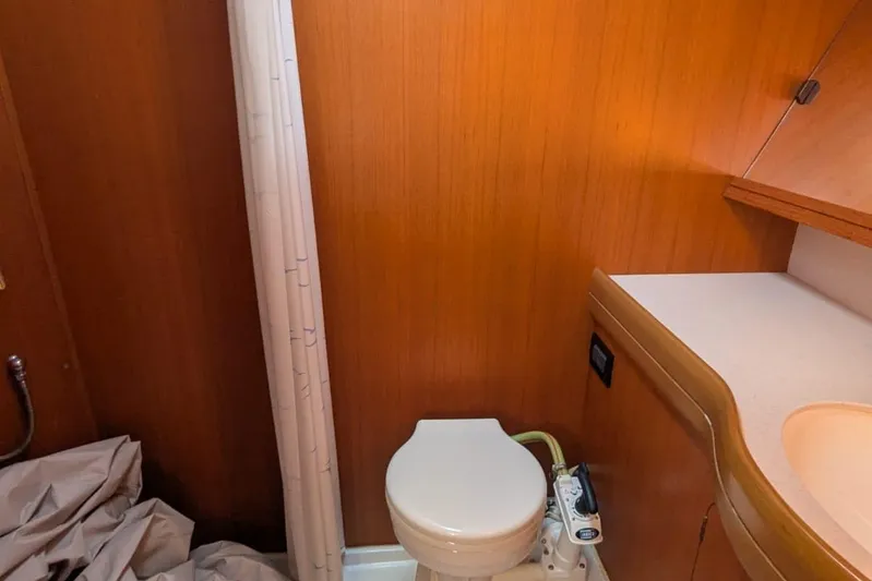  Yacht Photos Pics Bathroom interior of 2006 Grand Soleil 50 yacht with wooden paneling and compact toilet.