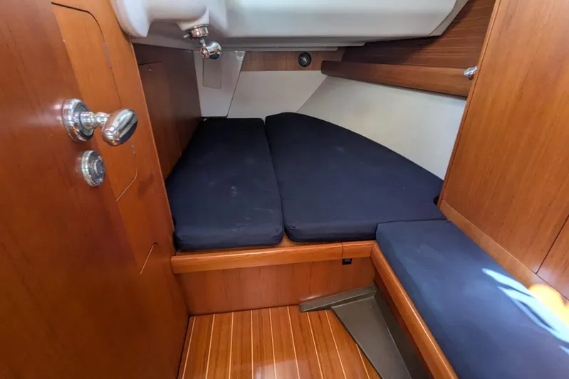  Yacht Photos Pics 2006 Grand Soleil 50 yacht cabin with wooden interior and blue cushions.