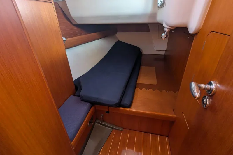  Yacht Photos Pics 2006 Grand Soleil 50 yacht cabin with wooden interior and cushioned seating.