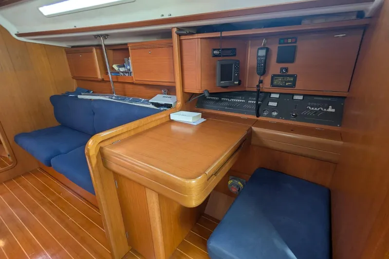 Yacht Photos Pics Interior of 2006 Grand Soleil 50 yacht with navigation station and seating area.