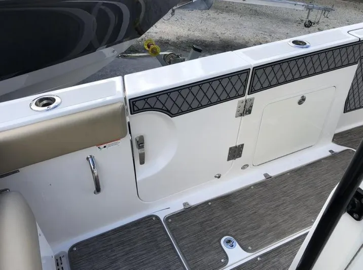  Yacht Photos Pics 2018 Wellcraft 302 Fisherman boat interior with cushioned seating and storage compartments.