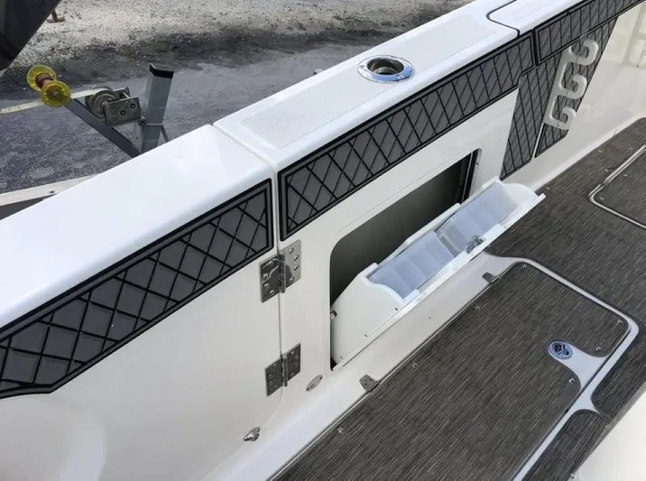  Yacht Photos Pics 2018 Wellcraft 302 Fisherman boat interior with storage compartment and textured flooring.