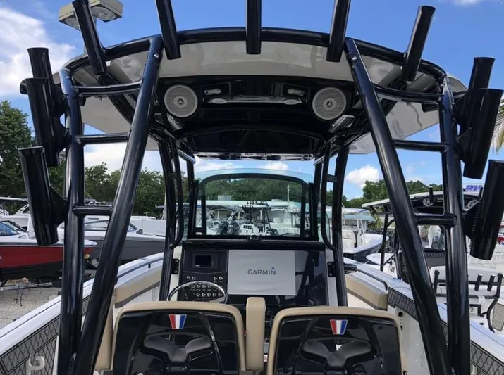  Yacht Photos Pics 2018 Wellcraft 302 Fisherman boat with Garmin navigation, black T-top, and dual seating.