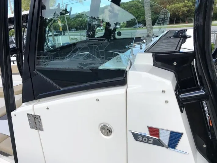  Yacht Photos Pics 2018 Wellcraft 302 Fisherman boat, side view with logo and sleek design.