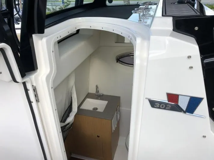  Yacht Photos Pics 2018 Wellcraft 302 Fisherman boat interior with compact sink and storage.