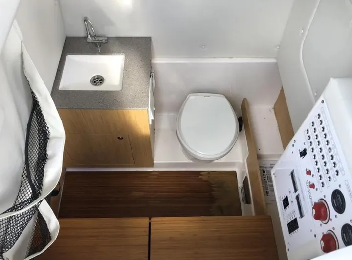  Yacht Photos Pics 2018 Wellcraft 302 Fisherman boat interior with sink, toilet, and control panel.