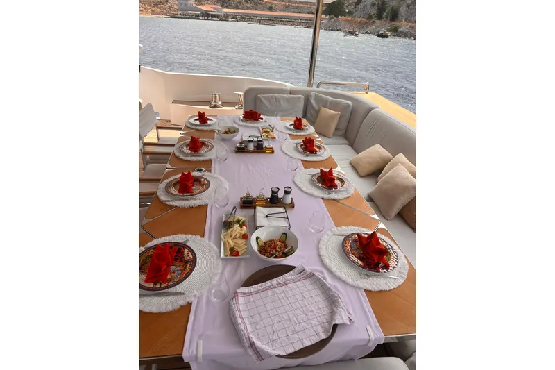 Dagusha Yacht Photos Pics Luxurious dining setup on Azimut Grande 35 Metri yacht, 2020, with elegant tableware and scenic water view.