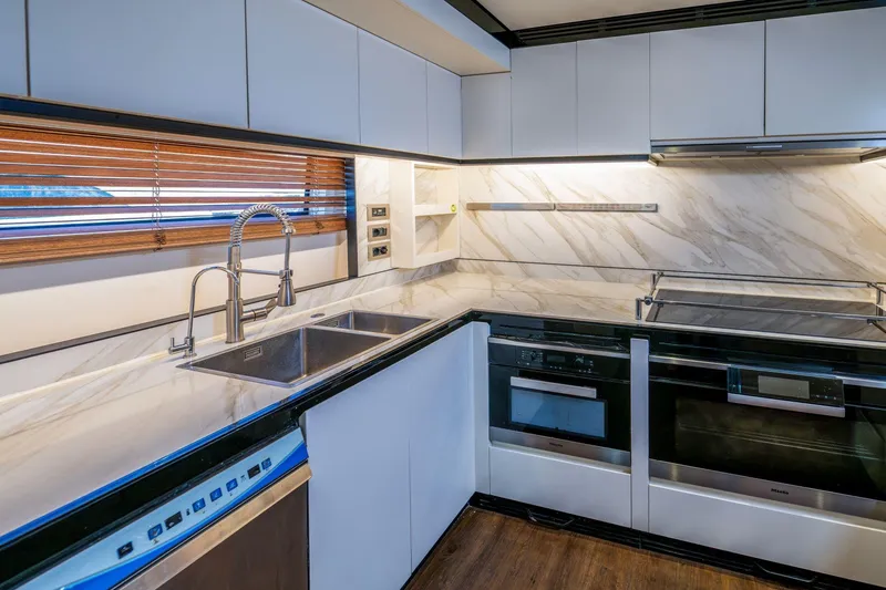 Dagusha Yacht Photos Pics Modern kitchen interior on 2020 Azimut Grande 35 Metri yacht, featuring sleek appliances and marble countertops.