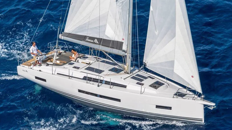  Yacht Photos Pics 2025 Hanse 410 sailboat navigating blue ocean waters, showcasing sleek design and spacious deck.