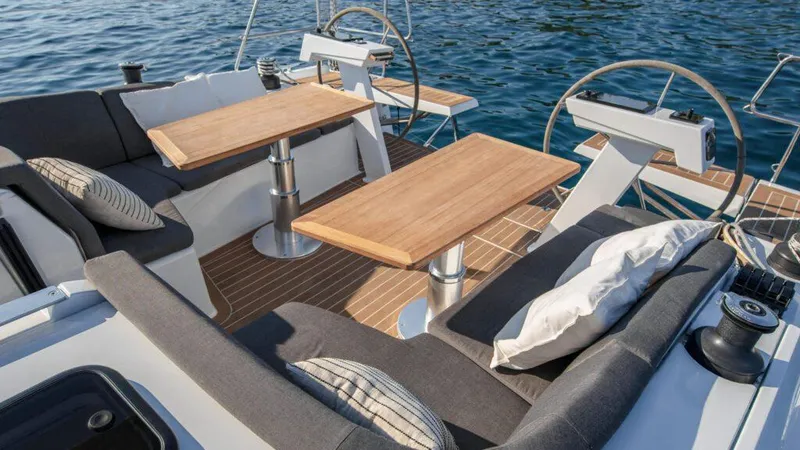  Yacht Photos Pics Luxurious 2025 Hanse 410 yacht deck with elegant seating and wooden tables.
