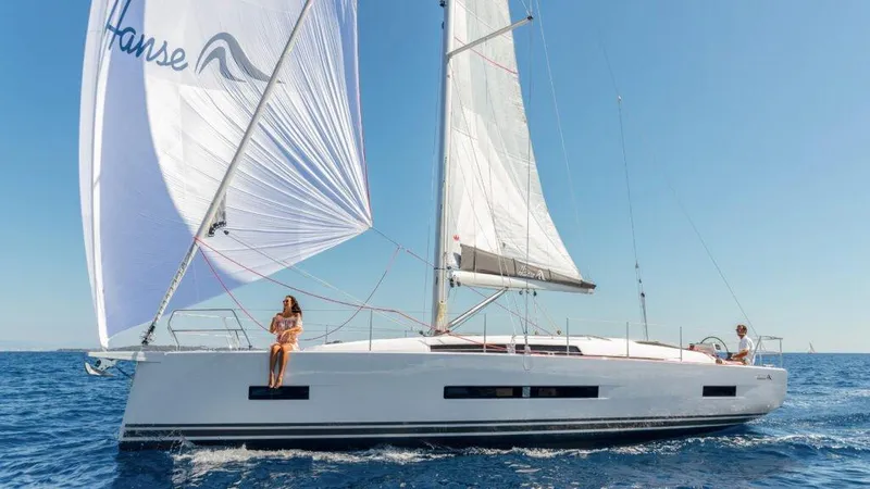  Yacht Photos Pics 2025 Hanse 410 sailboat cruising on open sea under clear blue sky.