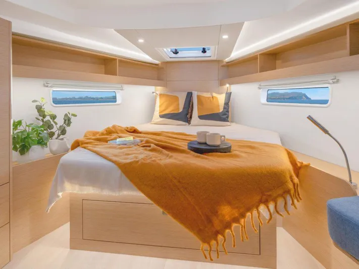  Yacht Photos Pics Luxurious cabin interior of 2025 Hanse 410 yacht with cozy bed and modern decor.