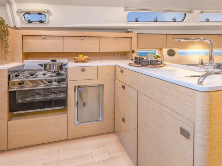  Yacht Photos Pics Modern kitchen interior of 2025 Hanse 410 yacht with sleek cabinetry and appliances.