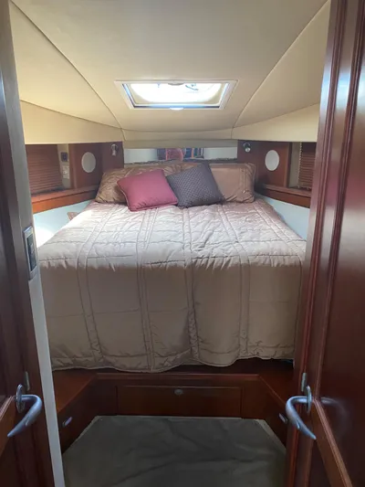  Yacht Photos Pics Luxurious bedroom interior of 2006 Sea Ray 48 Sundancer yacht with skylight and plush bedding.