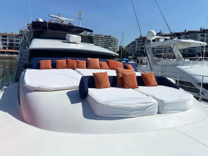New Beginning Yacht Photos Pics Luxurious 1990 Cheoy Lee 75 yacht with sunbathing deck and cushions in a marina setting.