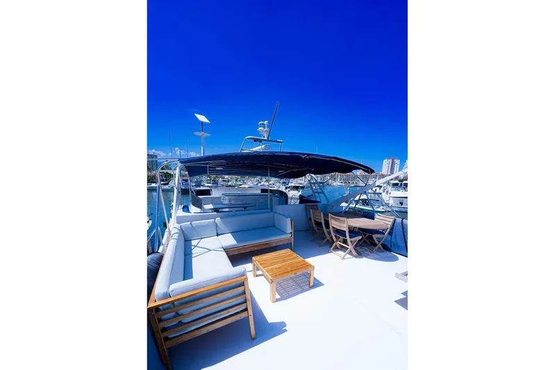 New Beginning Yacht Photos Pics Luxurious 1990 Cheoy Lee 75 yacht deck with seating and dining area under clear blue sky.