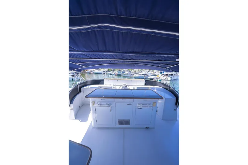 New Beginning Yacht Photos Pics Flybridge view of 1990 Cheoy Lee 75 yacht with covered seating and cabinetry.