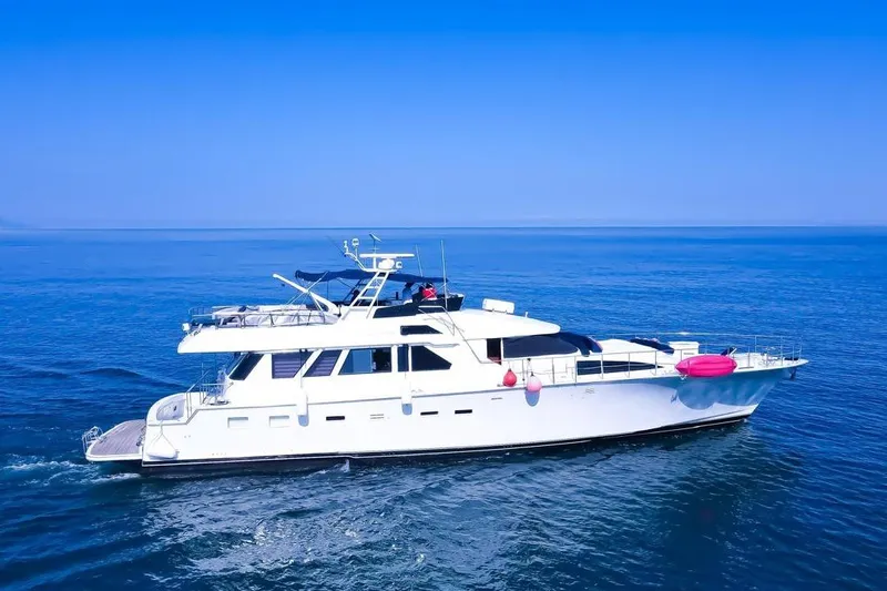 New Beginning Yacht Photos Pics 1990 Cheoy Lee 75 yacht cruising on calm blue ocean waters.