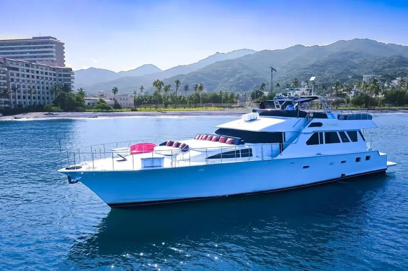 New Beginning Yacht Photos Pics Luxury 1990 Cheoy Lee 75 yacht cruising near scenic coastline and mountains.