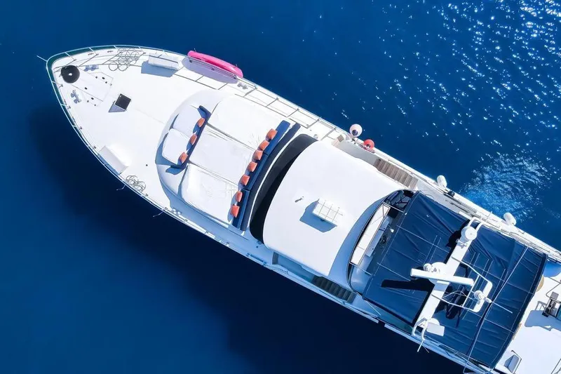 New Beginning Yacht Photos Pics Aerial view of 1990 Cheoy Lee 75 yacht on blue ocean water.