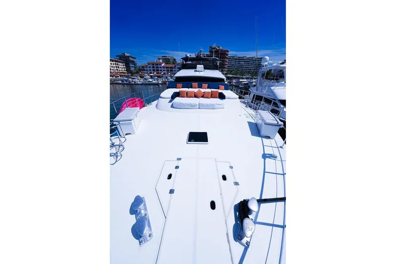 New Beginning Yacht Photos Pics Luxurious 1990 Cheoy Lee 75 yacht deck with seating, docked in a marina.