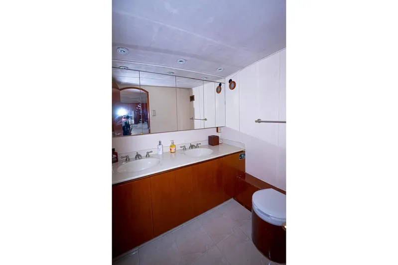 New Beginning Yacht Photos Pics Bathroom interior of 1990 Cheoy Lee 75 yacht with dual sinks and mirrors.