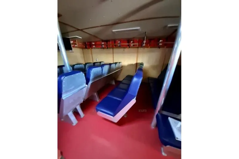  Yacht Photos Pics Interior of a custom 2008 vehicle with blue seats and red flooring.