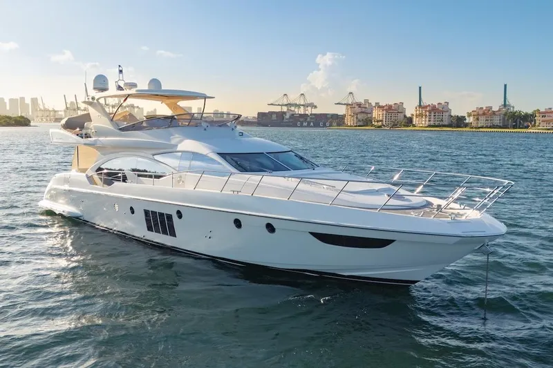 Drakkar Yacht Photos Pics Luxurious 2012 Azimut Evolution yacht cruising in a scenic harbor setting.