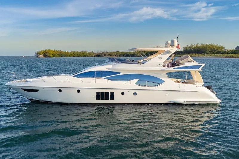 Drakkar Yacht Photos Pics Luxurious 2012 Azimut Evolution yacht cruising on serene waters under a clear sky.