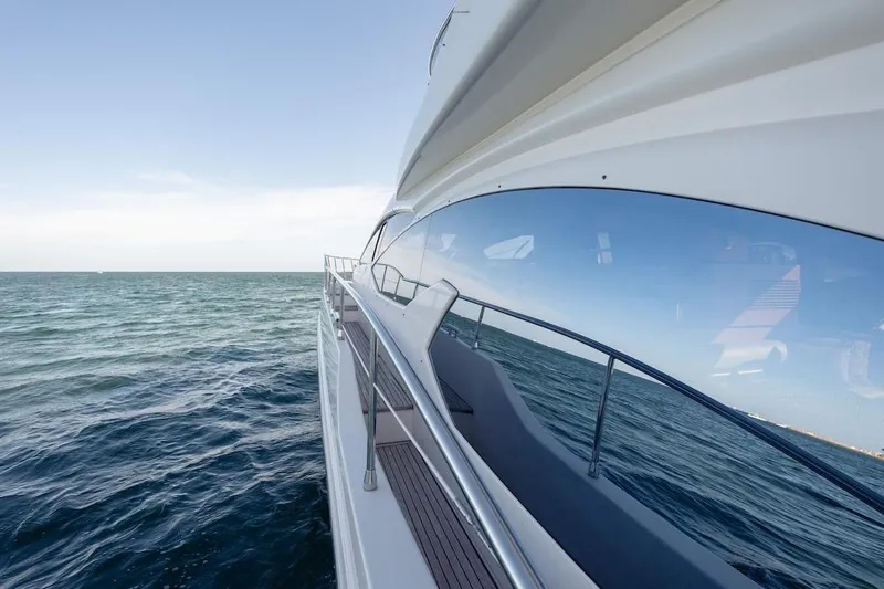 Drakkar Yacht Photos Pics 2012 Azimut Evolution yacht cruising on open sea, reflecting blue sky and ocean.