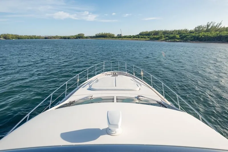 Drakkar Yacht Photos Pics Bow view of 2012 Azimut Evolution yacht cruising on a serene waterway.