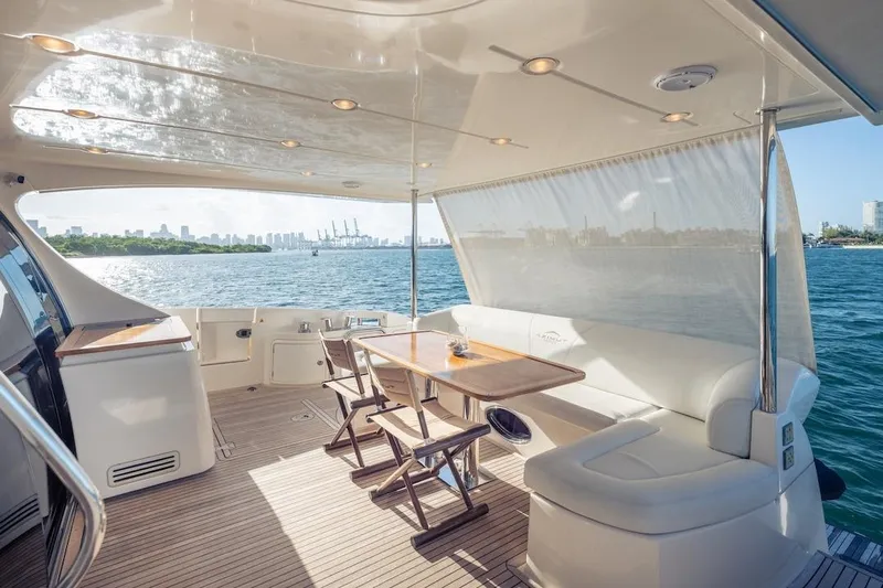 Drakkar Yacht Photos Pics Luxurious 2012 Azimut Evolution yacht deck with seating, table, and ocean view.